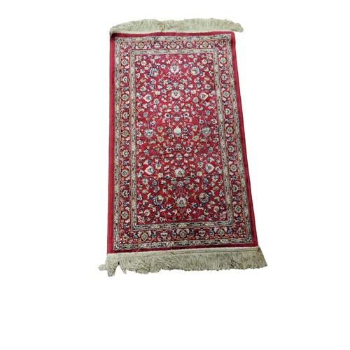 150 - A WOOL RUNNER the wine ground with central stylised floral panel within a conforming border 
350cm (... 