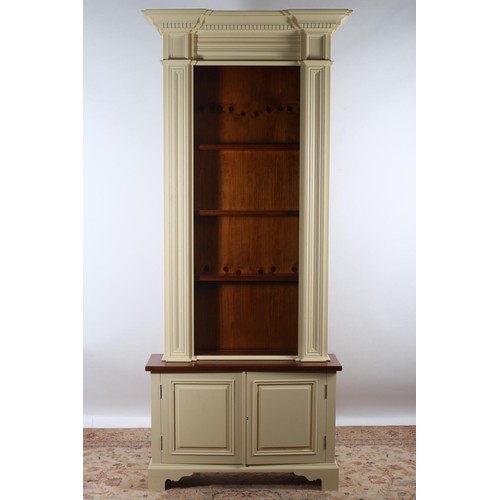 604 - A CHALON PINE AND PAINTED OPEN FRONT BOOKCASE of inverted breakfront outline the dentil moulded corn... 