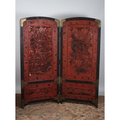 475 - A 19TH CENTURY CHINESE CINNABAR TWO FOLD SCREEN each screen moulded in high relief with pagodas figu... 