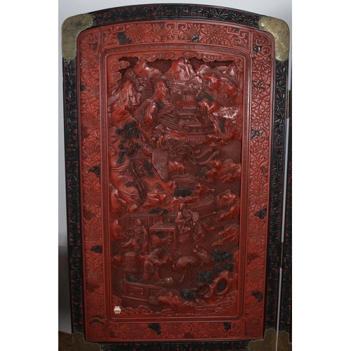 475 - A 19TH CENTURY CHINESE CINNABAR TWO FOLD SCREEN each screen moulded in high relief with pagodas figu... 