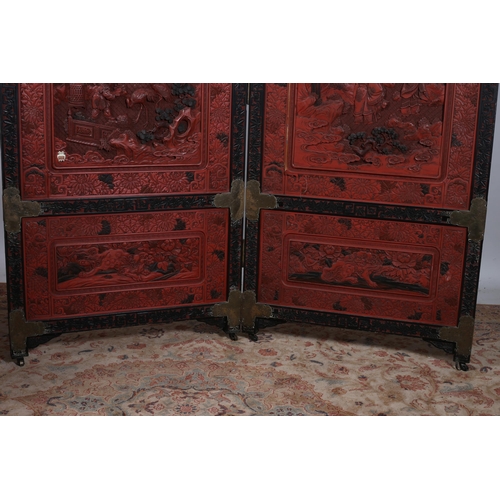 475 - A 19TH CENTURY CHINESE CINNABAR TWO FOLD SCREEN each screen moulded in high relief with pagodas figu... 