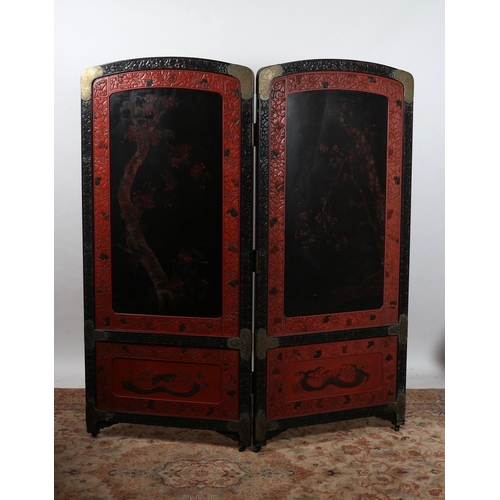 475 - A 19TH CENTURY CHINESE CINNABAR TWO FOLD SCREEN each screen moulded in high relief with pagodas figu... 