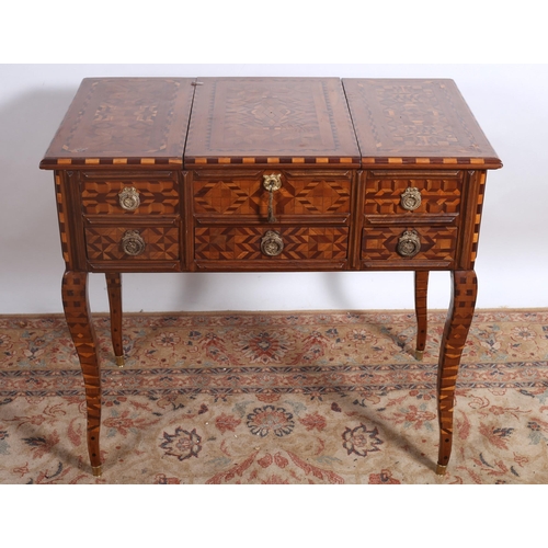 343 - A CONTINENTAL PARQUETRY DRESSING TABLE of rectangular outline the shaped top with central hinged com... 