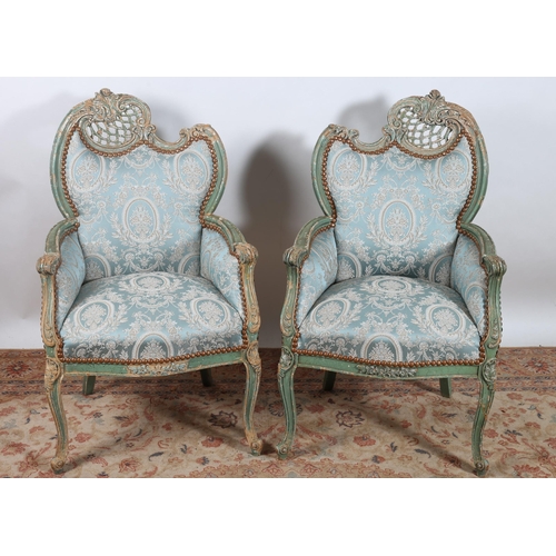 536 - A PAIR OF CONTINENTAL SHABBY CHIC HARDWOOD AND UPHOLSTERED ARMCHAIRS each with a foliate and pierced... 