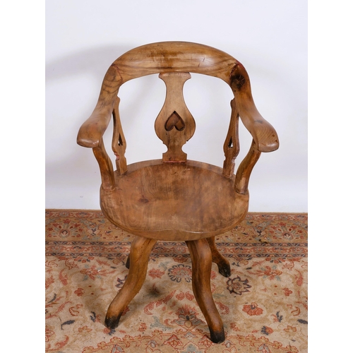 537 - A VINTAGE HARDWOOD TUB SHAPED SWIVEL LIBRARY CHAIR the curved top rail with scroll arm on a revolvin... 