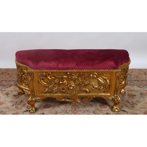 539 - A CONTINENTAL CARVED GILTWOOD STOOL the rectangular shaped upholstered seat above a carved apron on ... 