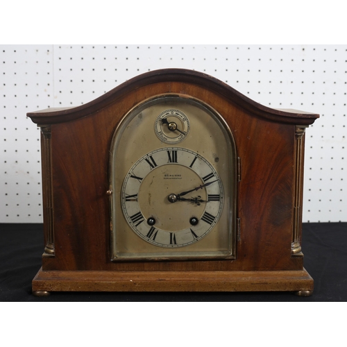 562 - A VINTAGE WALNUT AND GILT BRASS MOUNTED MANTEL CLOCK of rectangular arched outline the rectangular a... 