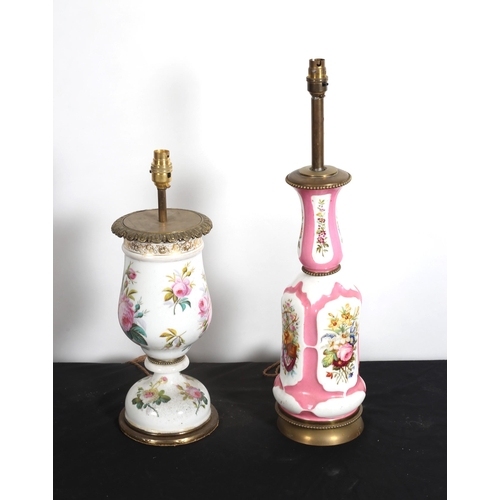 566 - TWO CONTINENTAL PORCELAIN AND GILT BRASS TABLE LAMPS each with a white ground and floral decoration