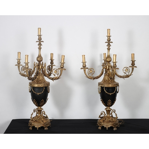 130 - A PAIR OF CONTINENTAL GILT BRASS AND TOLEWARE FIVE BRANCH TABLE LAMPS each of urn form the foliate s... 