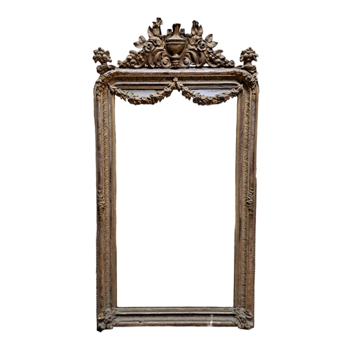 141 - A CONTINENTAL GILT FRAME MIRROR the rectangular plate within a foliate moulded frame with urn, flowe... 