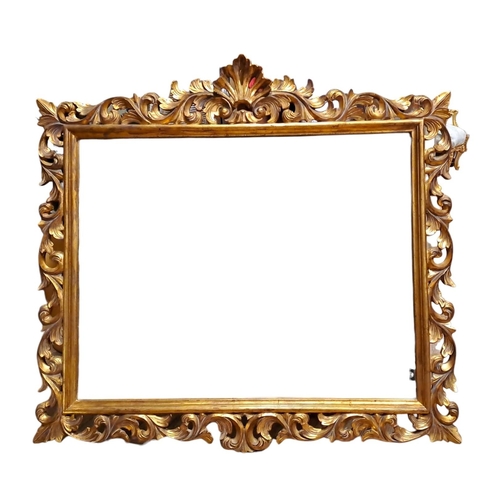 144 - A CONTINENTAL GILT FRAME MIRROR the rectangular bevelled glass plate within a pierced foliate frame ... 