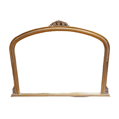 146 - A VICTORIAN DESIGN GILT FRAME OVERMANTEL MIRROR the rectangular arched bevelled glass plate within a... 