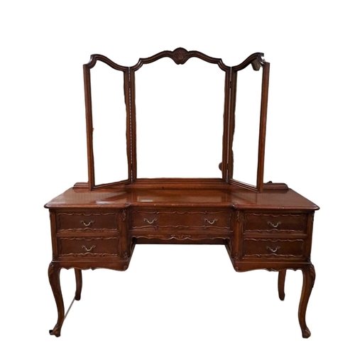 181 - A CONTINENTAL KINGWOOD DRESSING TABLE of inverted breakfront outline with triptych swivel mirrors ab... 