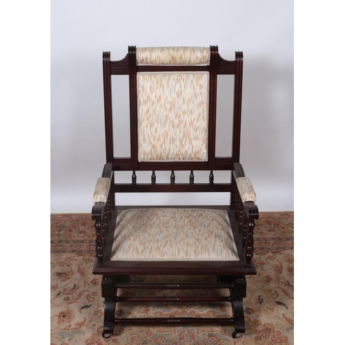 185 - AN EDWARDIAN DESIGN MAHOGANY AND UPHOLSTERED ROCKING CHAIR the rectangular open back with upholstere... 