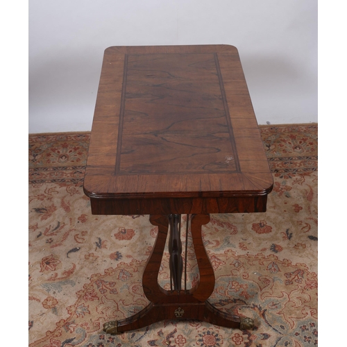 187 - A REGENCY DESIGN ROSEWOOD CROSSBANDED COFFEE TABLE of rectangular outline the shaped top raised on l... 