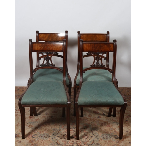 189 - A SET OF FOUR REGENCY MAHOGANY DINING CHAIRS each with a curved top rail and pierced foliate carved ... 