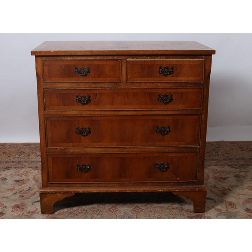 193 - A YEW WOOD CROSSBANDED CHEST of rectangular outline the shaped top above two short and three long gr... 