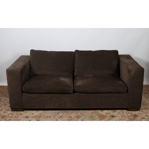 198 - A DESIGNER UPHOLSTERED SETTEE of rectangular outline with loose cushions on moulded legs 
191cm (w)