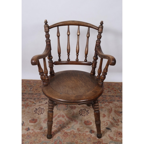 201 - A VINTAGE BEECH FRAME ELBOW CHAIR the shaped top rail with baluster splats and scroll arms with pane... 