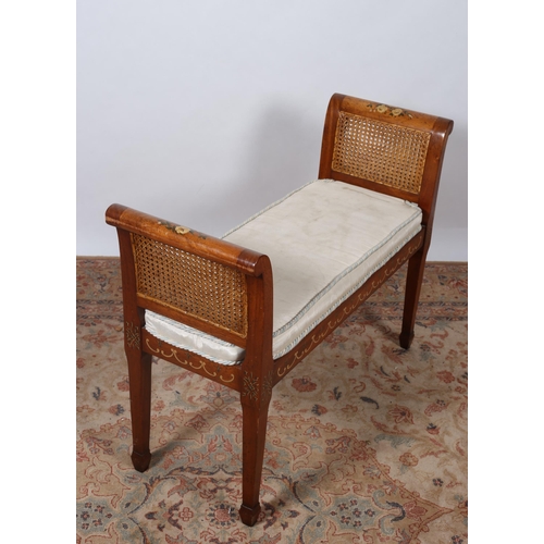 202 - A MAHOGANY AND POLYCHROME DUET STOOL of rectangular outline with caned panel ends with loose cushion... 