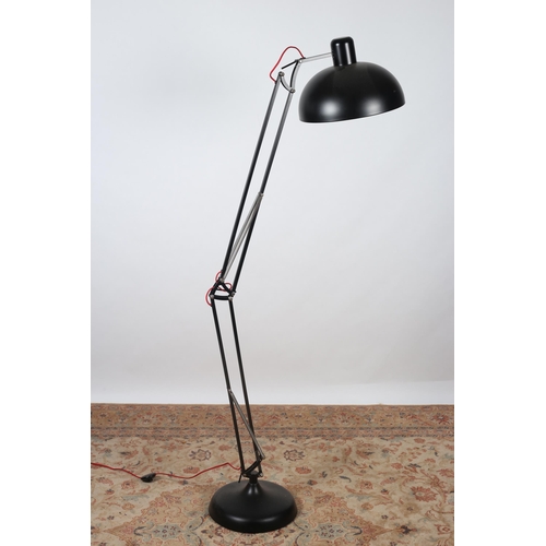 203 - A DESIGNER BLACK METAL ANGLEPOISE FLOOR STANDARD LAMP with dome shade raised on a circular spreading... 