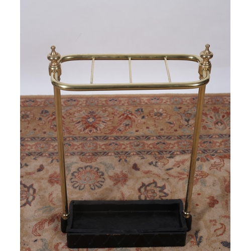 205 - A VICTORIAN STYLE BRASS AND CAST IRON FOUR COMPARTMENT STICK STAND on cylindrical supports with urn ... 