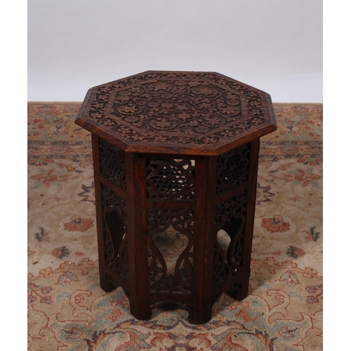 208 - A BURMESE CARVED WOOD OCTAGONAL SHAPE TABLE on folding stand 
42cm (h) x 38cm (w) x 38cm (d)