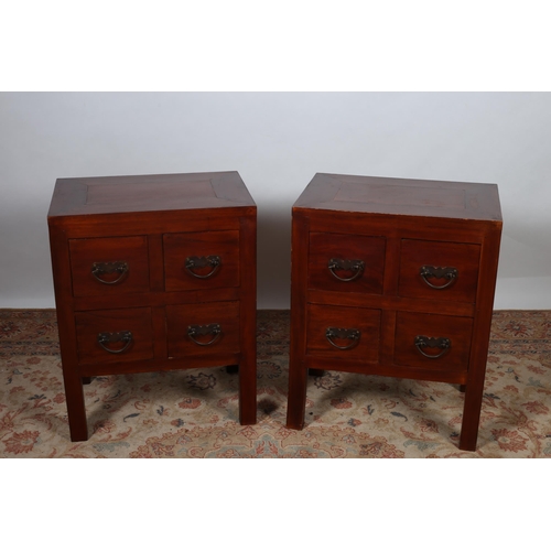 215 - A PAIR OF ORIENTAL HARDWOOD CHESTS each of rectangular outline the shaped tops above four short draw... 