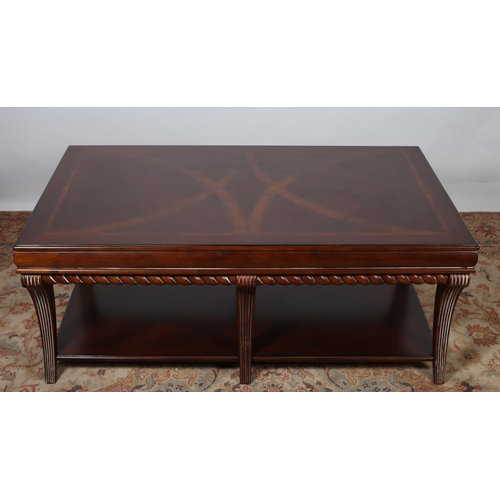 216 - A REGENCY DESIGN MAHOGANY COFFEE TABLE of rectangular outline the shaped top raised on reeded sabre ... 