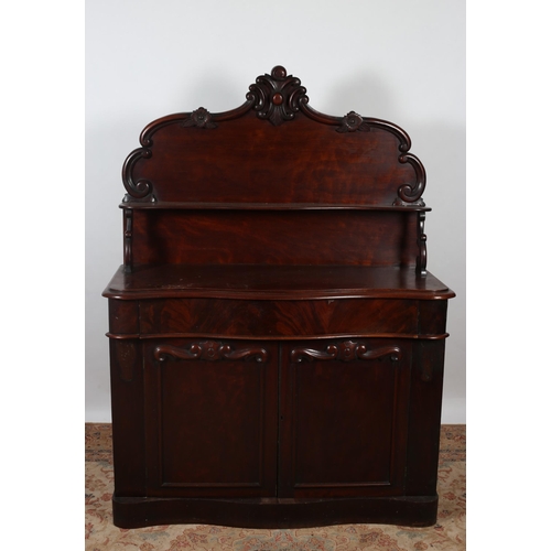 243 - A 19TH CENTURY MAHOGANY SIDE CABINET the superstructure with serpentine moulded shelf raised on scro... 