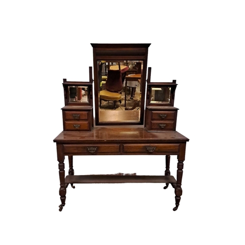 246 - AN EDWARDIAN MAHOGANY DRESSING TABLE the superstructure with bevelled glass mirror flanked by four s... 