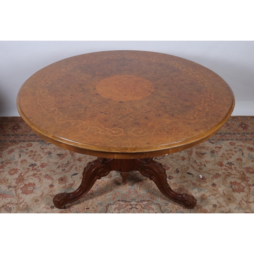 248 - A VICTORIAN STYLE BURR WALNUT AND MARQUETRY POD TABLE the circular moulded top above a carved balust... 