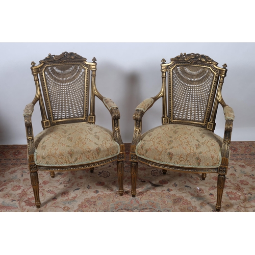 249 - A PAIR OF CONTINENTAL GILTWOOD AND UPHOLSTERED ARMCHAIRS each with a caned back with musical trophy ... 