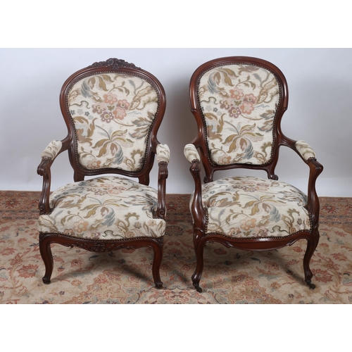 251 - TWO VICTORIAN MAHOGANY ARMCHAIRS each with a shaped top rail with upholstered back and seat on cabri... 