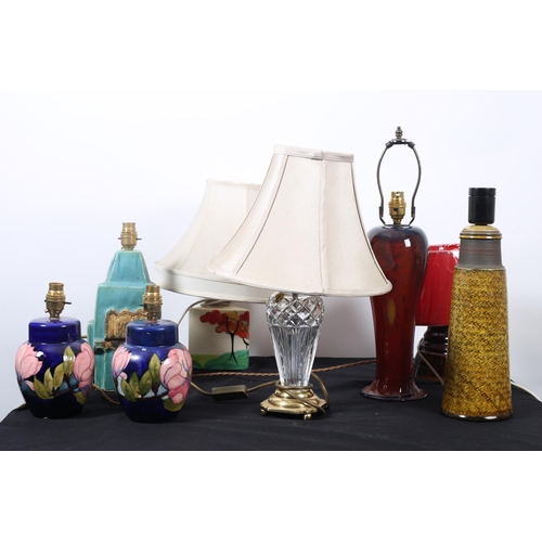 255 - A COLLECTION OF VARIOUS LAMPS to include a pair of Moorcroft design table lamps, a Clarice Cliff sty... 