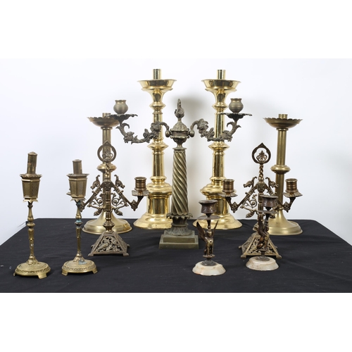 256 - A COLLECTION OF BRASS CANDLESTICKS to include two pairs of Gothic design candlesticks, a two branch ... 