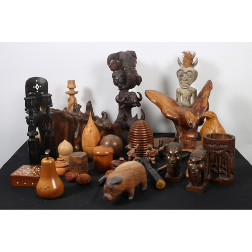 260 - A COLLECTION OF HARDWOOD SCULPTURES a pair of ebony carved candlesticks, a carved bamboo vessel, a c... 