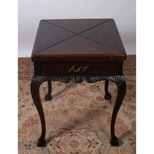 327 - AN EDWARDIAN CARVED MAHOGANY ENVELOPE CARD TABLE the square moulded top with hinged leaves with baiz... 