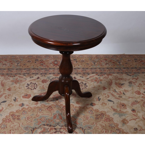 329 - A VICTORIAN STYLE MAHOGANY OCCASIONAL TABLE of circular outline the shaped top above a baluster colu... 