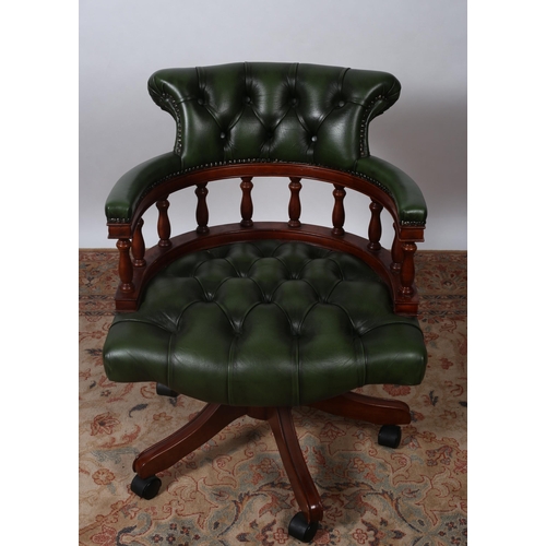 334 - A MAHOGANY AND HIDE UPHOLSTERED SWIVEL OFFICE CHAIR with deep buttoned upholstered back and seat wit... 