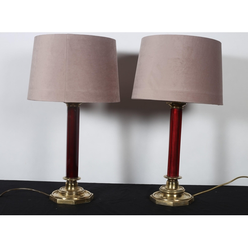 352 - A PAIR OF 19TH CENTURY BRASS AND RUBY GLASS TABLE LAMPS each with an octagonal shaped column above a... 