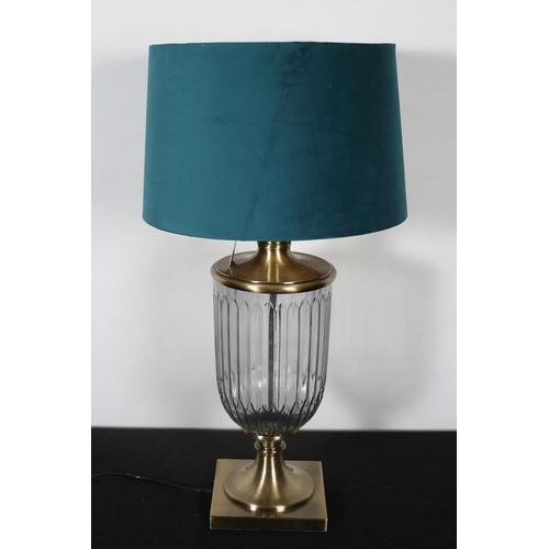 354 - A BRUSHED BRASS AND GLAZED TABLE LAMP of ovoid tapering form raised on a circular spreading foot and... 