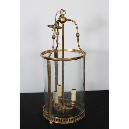 361 - A GILT BRASS AND GLAZED THREE LIGHT HALL LANTERN of cylindrical form with pierced circlet 
60cm (h) ... 