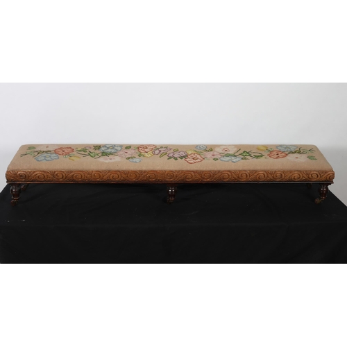 369 - A VINTAGE MAHOGANY AND UPHOLSTERED STOOL of rectangular outline the needlework upholstered seat abov... 