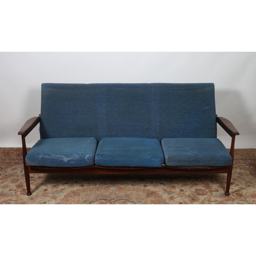 398 - A TWO PIECE VINTAGE TEAK AND UPHOLSTERED SUITE comprising a three seater settee the upholstered back... 