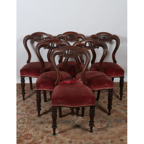 402 - A SET OF SIX VICTORIAN MAHOGANY DINING CHAIRS each with a shaped top rail above an upholstered seat ... 