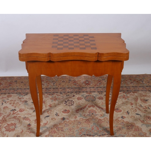 407 - A CONTINENTAL SATIN BIRCH FOLDOVER CARD TABLE the serpentine hinged top with chess board containing ... 