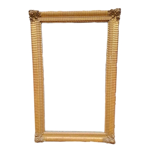 416 - A 19TH CENTURY GILTWOOD AND GESSO MIRROR the rectangular plate within a gadrooned frame with flowerh... 