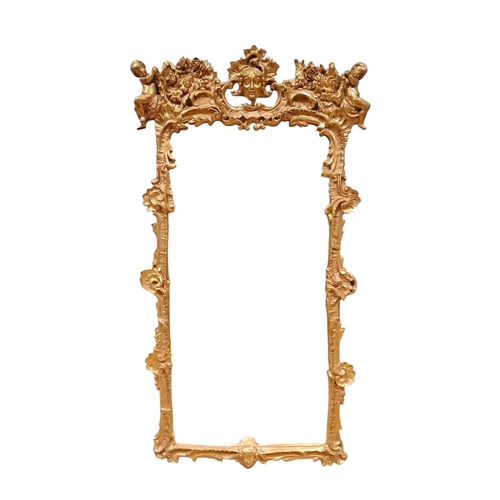 417 - A GILT FRAME MIRROR the rectangular plate within a C-scroll, shell and foliate frame with figural ma... 