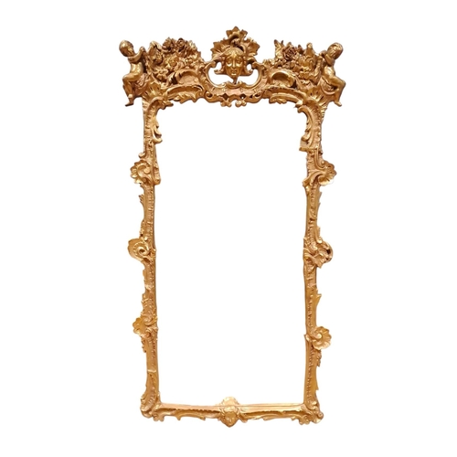 418 - A GILT FRAME MIRROR the rectangular plate within a C-scroll, shell and foliate frame with figural ma... 